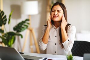 young-woman-is-sitting-at-a-desk-in-the-office-and-2026-03-20-03-24-21-utc - Serenity Healthy Smiles